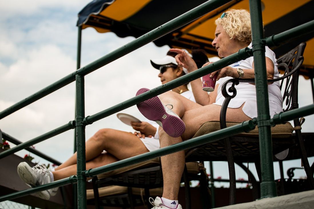 Lamia Beydoun (left) and Isobel Kleinman relax and watch others play tennis<br>
